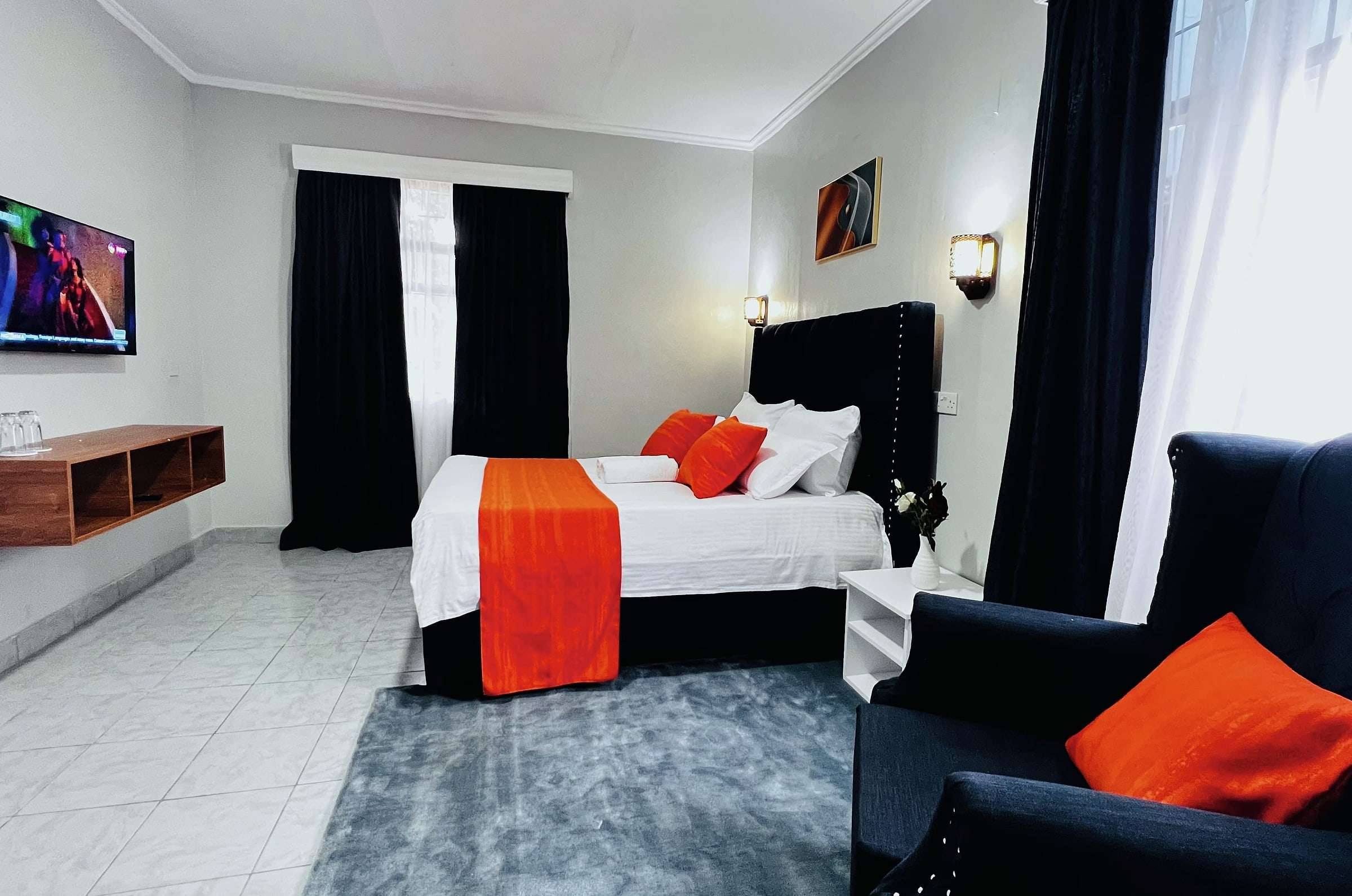 VIP room with wall-mounted TV, armchair and rug